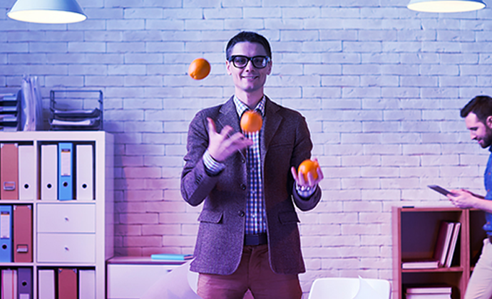 Business owner is juggling three balls in an office with Banjo's coloured gradient overlaid